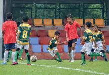 Teenagers Take to the Field to Have a Football Friendly..with the Adults